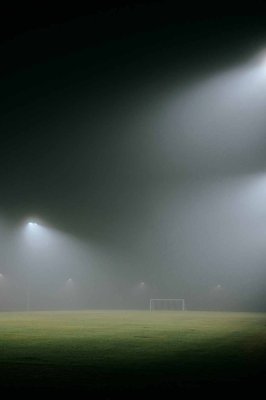Football stadium at night with bright floodlights