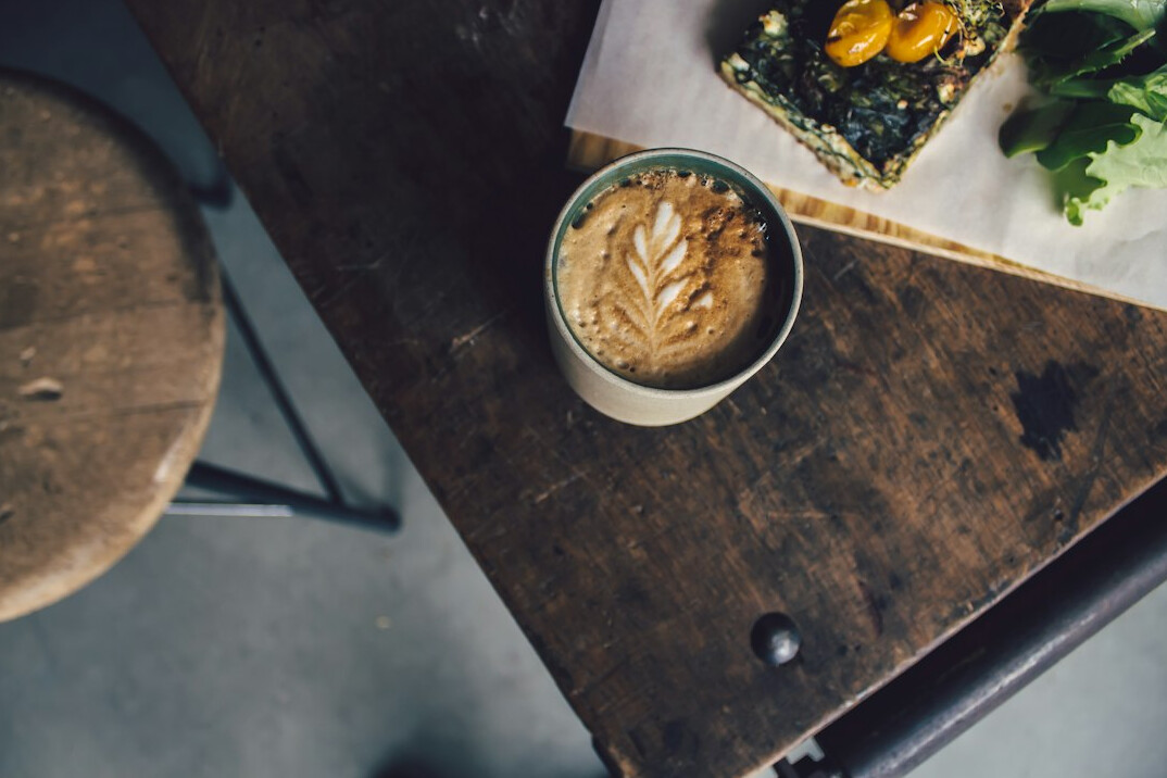 Newspaper and coffee on a wooden table